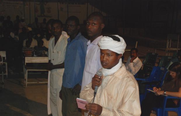 Youth line up to comment after an open-air screening of An African Answer in Abeche, eastern Chad
