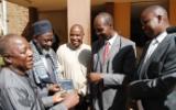 District Commissioner of Eldoret Christopher Wanjau and County Secretary Phillip Arap Meli receive DVD copies of 'An African Answer' from Pastor James Wuye and Imam Muhammad Ashafa. Joseph Wainaina is third from left.